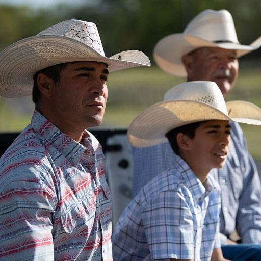 dad son and grandson wearing straw hats