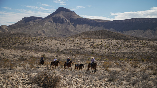 ethan lee on horses riding in mountains